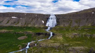 The Dettifoss waterfall on Iceland in green and rocky landscape: A highlight on the Island Tour!