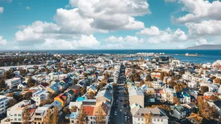 Colorful houses in Reykjavík, the capital of Iceland, photographed from above with sea and clouds in the background