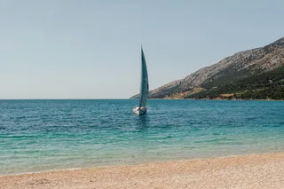 A sailboat in front of Zlatni Rat.