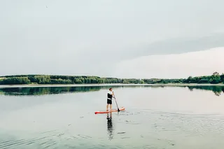 A man on a SUP in a lake.